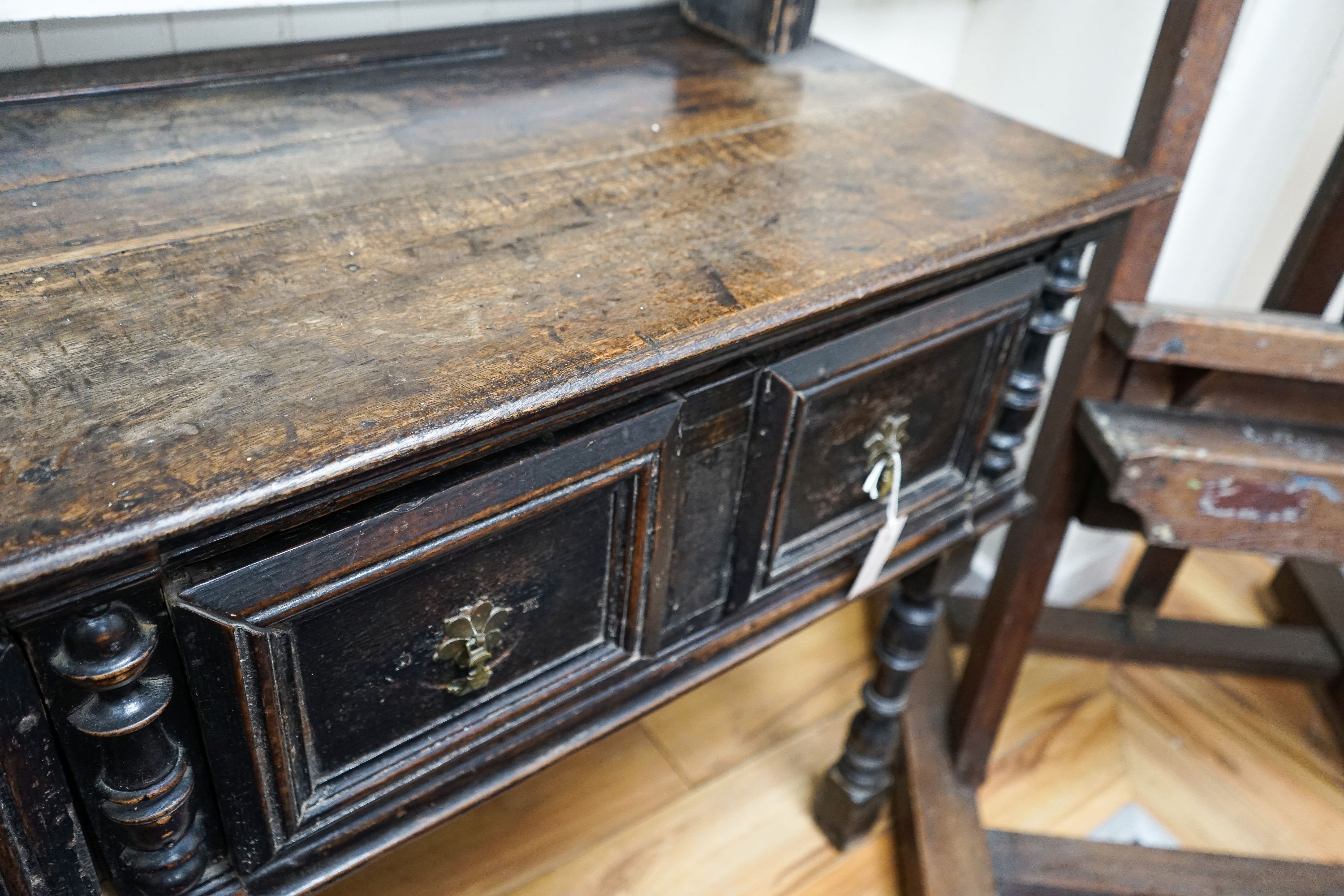 An 18th century and later oak dresser, the base fitted two drawers on turned supports, with two-tier plate rack over, width 147cm, depth 50cm, height 181cm